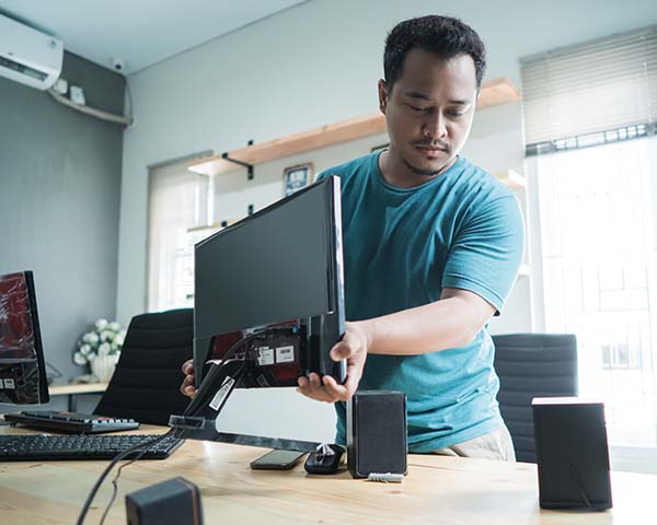 Man installing desktop computer for video conferencing
